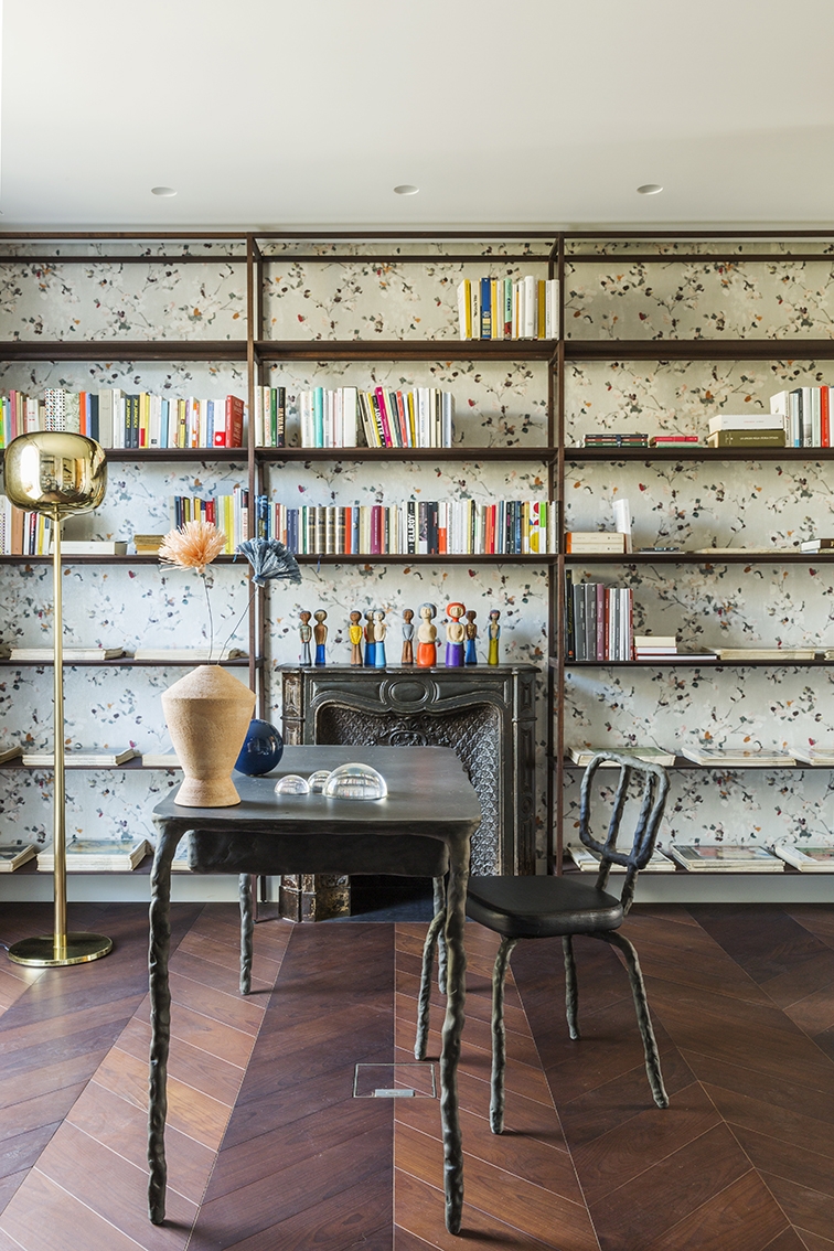 Studio. Dusk Dawn floor lamp by Ghidini 1961; wall bookcase with wengé wood veneer custom designed by Alvisi Kirimoto; Clay Dining Chair and Plain Clay Consolle with drawer by Maarten Baas; Better Together collection vase by Federica Bubani with paper flowers by Andrea Merendi; Vox Populi paperweight; lacquered ceramic sphere by Bosa; wallpaper by Metamorphosi; original bronze fireplace with painted wood sculptures by Giuseppe Palermo. ©Serena Eller Vainicher