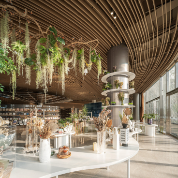 Lush greenery and sculptural design elements enhance the interior of Karv One's Leas exhibition hall in Dali, China.
