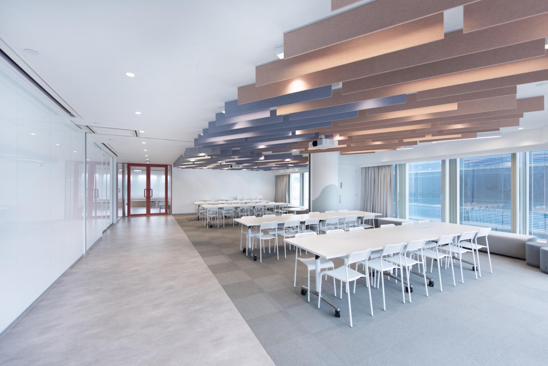 Modern, agile workspace designed by Bean Buro for Jardine Restaurant Group, featuring collaborative tables and innovative ceiling panels.
