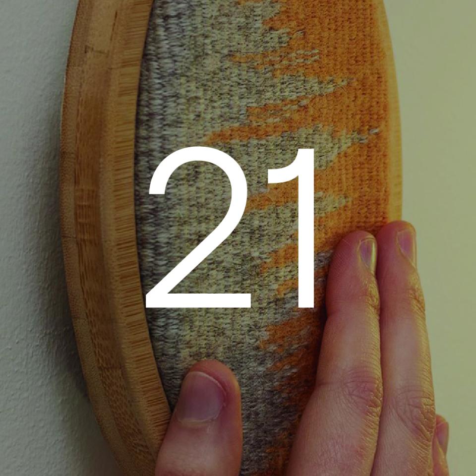 Hand touching a textured light switch with the number 