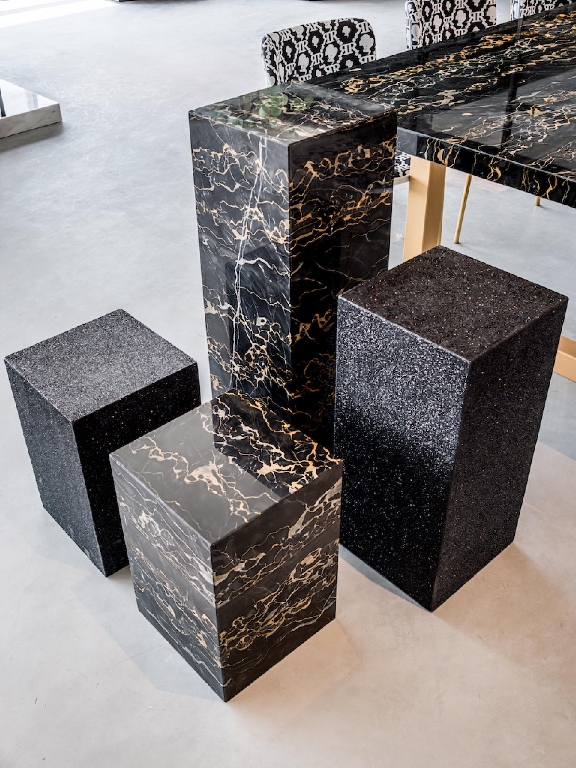 Elegant marble furniture pieces in a modern showroom, showcasing Dutch design by SolidNature for Reinders' headquarters.