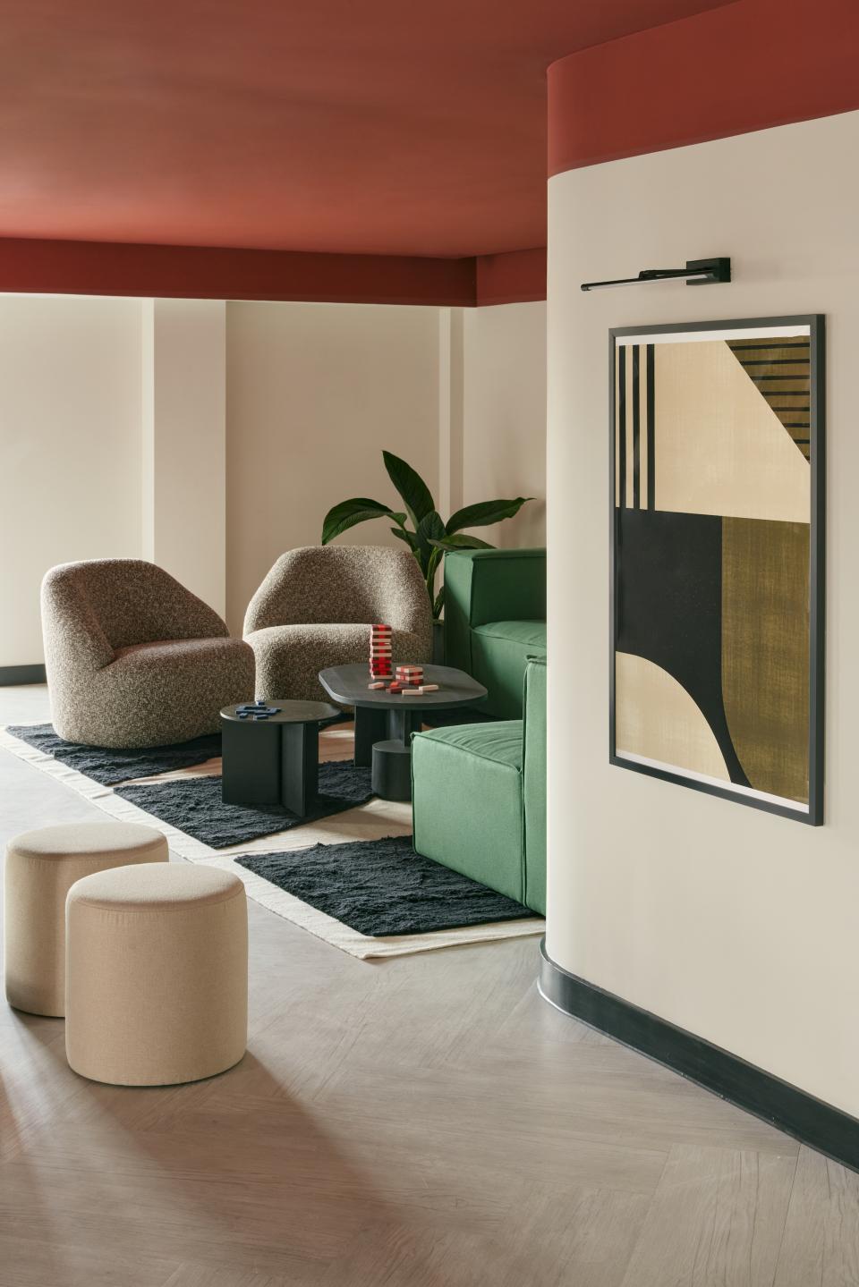 Contemporary lounge area featuring stylish furniture, art, and greenery, showcasing innovative design from Karndean Commercial and PLATFORM_.