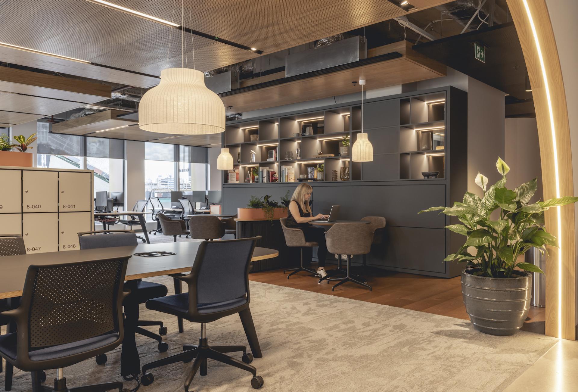 Modern workspace designed by Ekho Studio for AstraZeneca UK, featuring stylish furniture, plants, and collaborative areas.