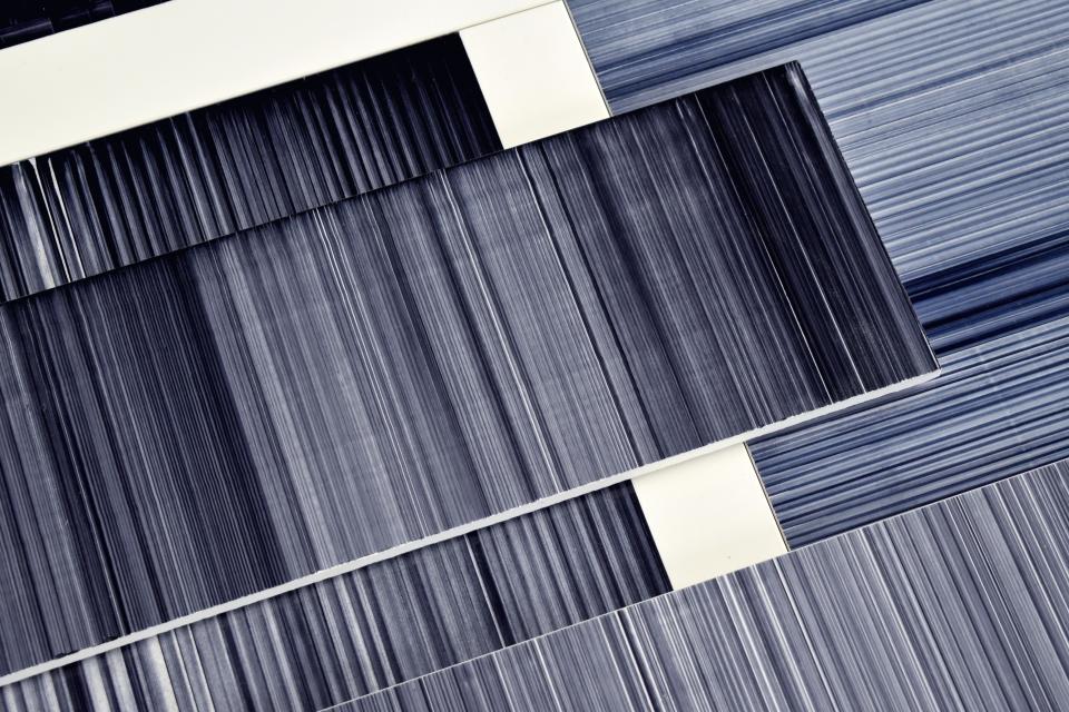 Contemporary ceramic tiles displaying a range of blue tones, showcasing Léa Mazy’s innovative design in the tile industry.