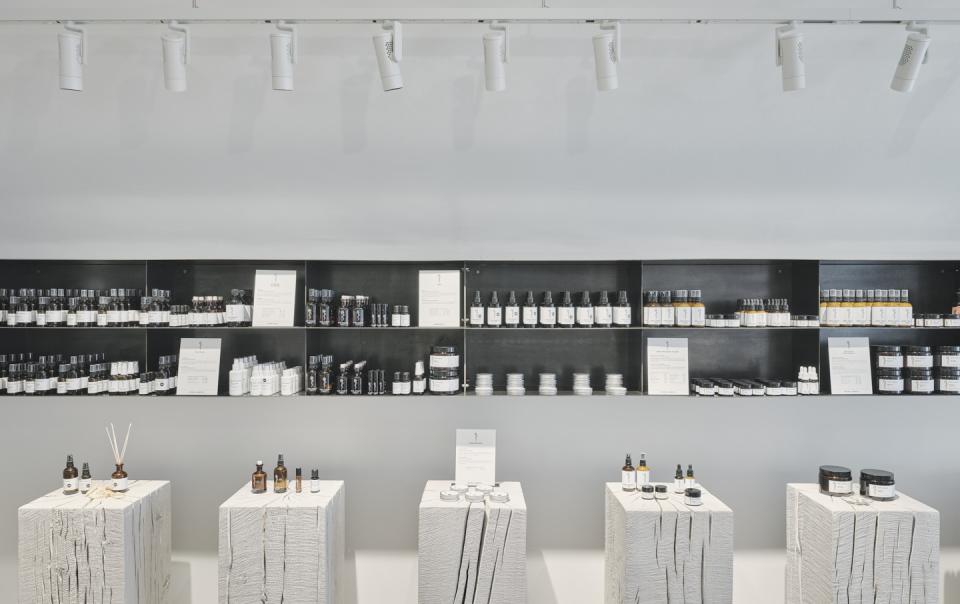 Natural cosmetics displayed on rustic wooden stands in Saint Charles' Salzburg store, highlighting eco-friendly beauty products.
