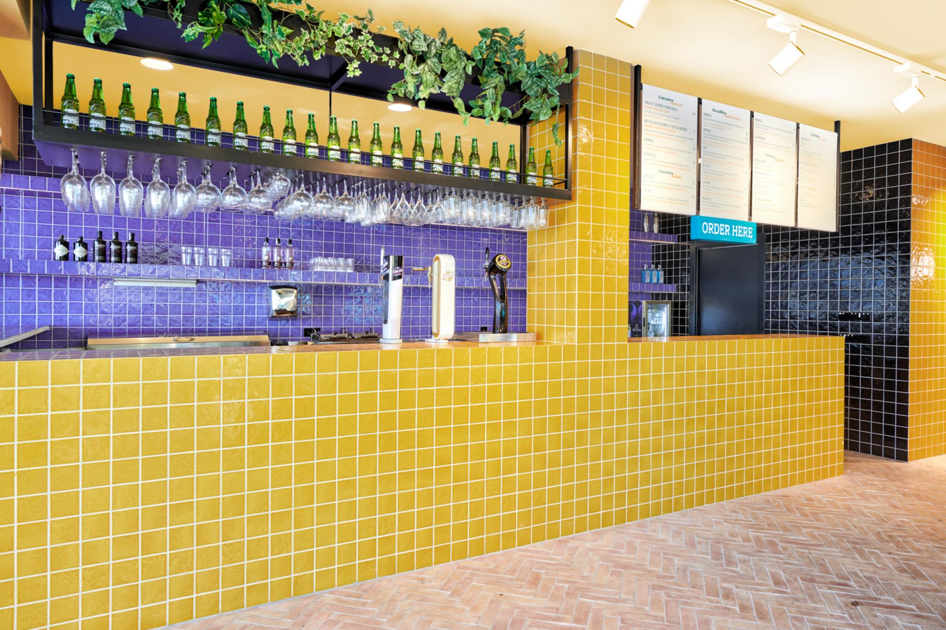 Brightly tiled bar area in Bar TORÖ, featuring Mediterranean-inspired design elements and vibrant colors in Ibiza.