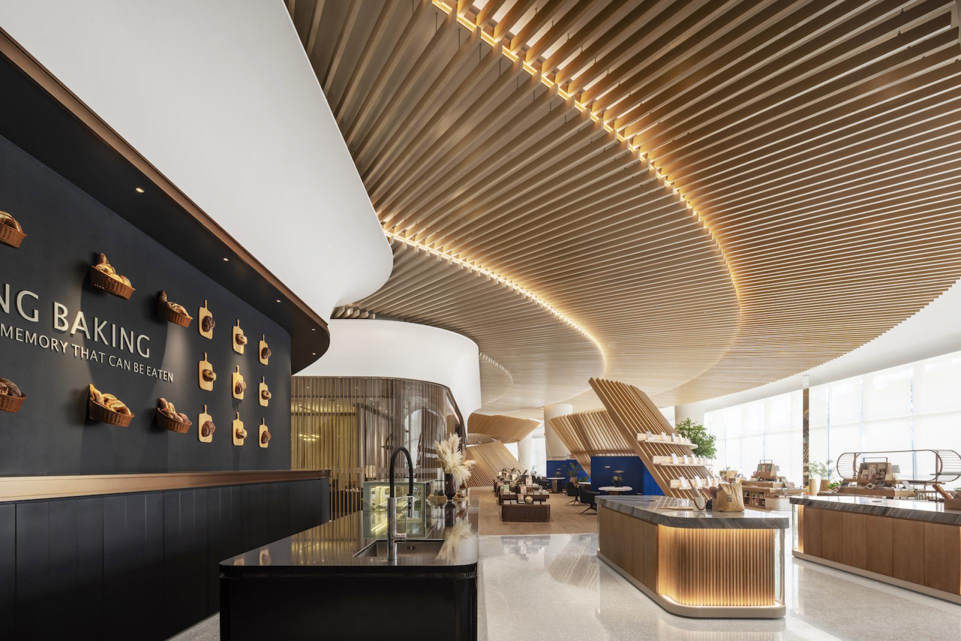 Elegant interior of The Florescence in Guangzhou showcasing sweeping, petal-inspired curves and a warm, inviting atmosphere.