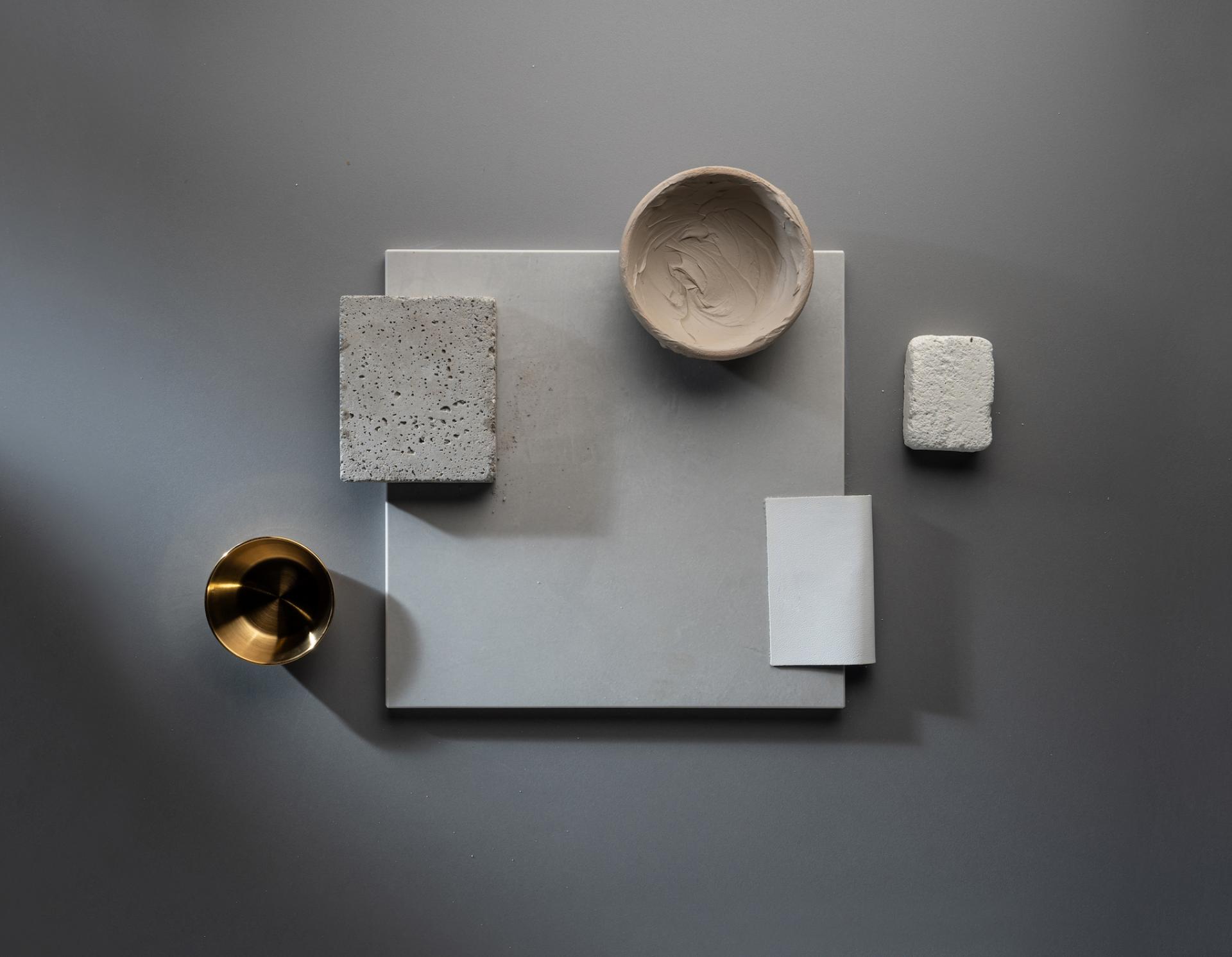 Stylish arrangement of Dekton® samples, including textured surfaces and materials, showcasing Cosentino's Onirika and Kraftizen collections.