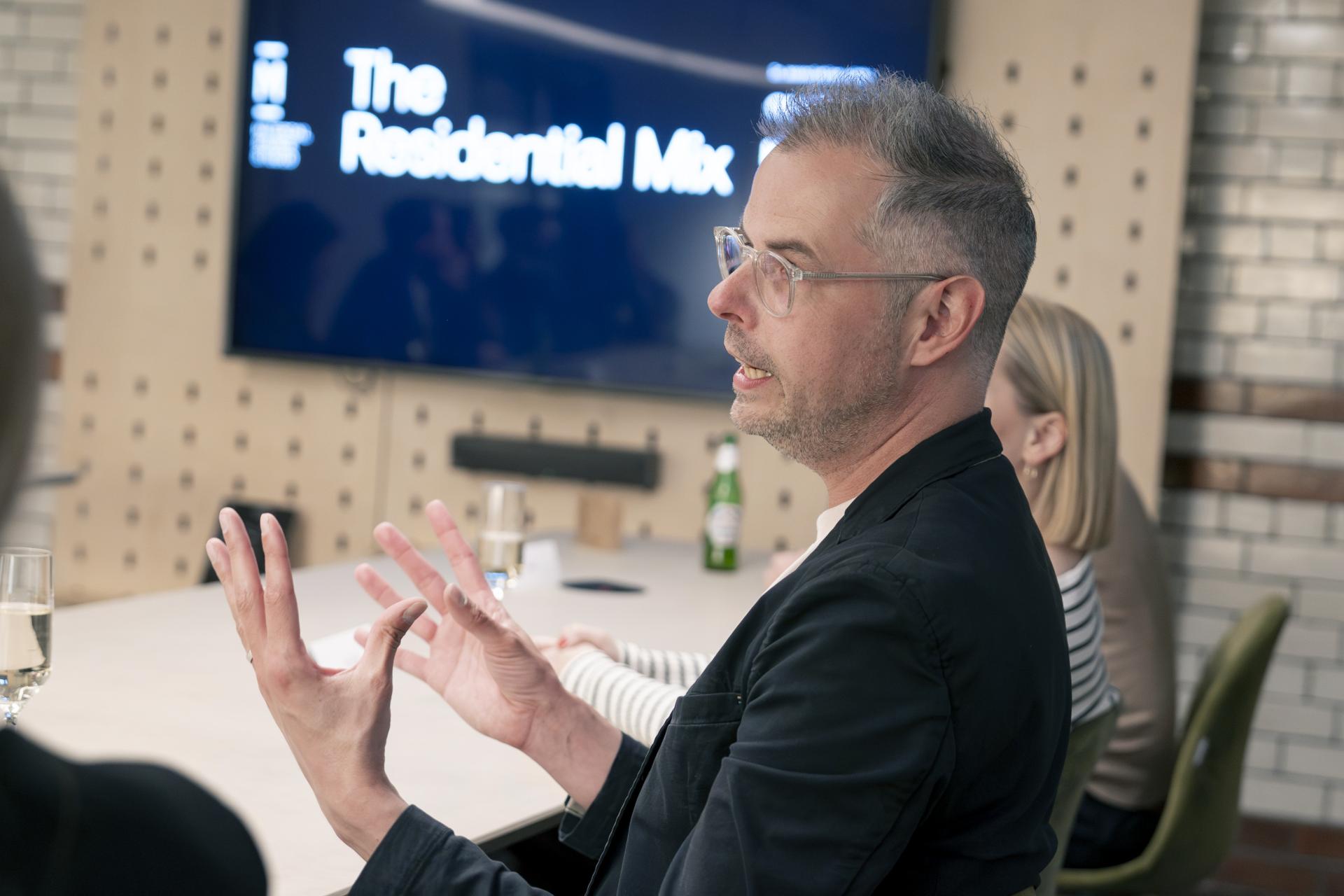 Discussion at a roundtable seminar on Manchester's residential property mix, featuring a speaker gesturing passionately.