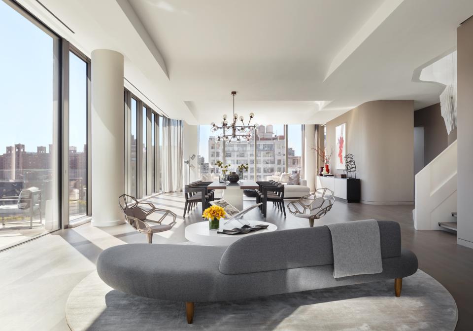 Luxurious interior of a Zaha Hadid-designed penthouse featuring modern furniture and expansive windows in West Chelsea.