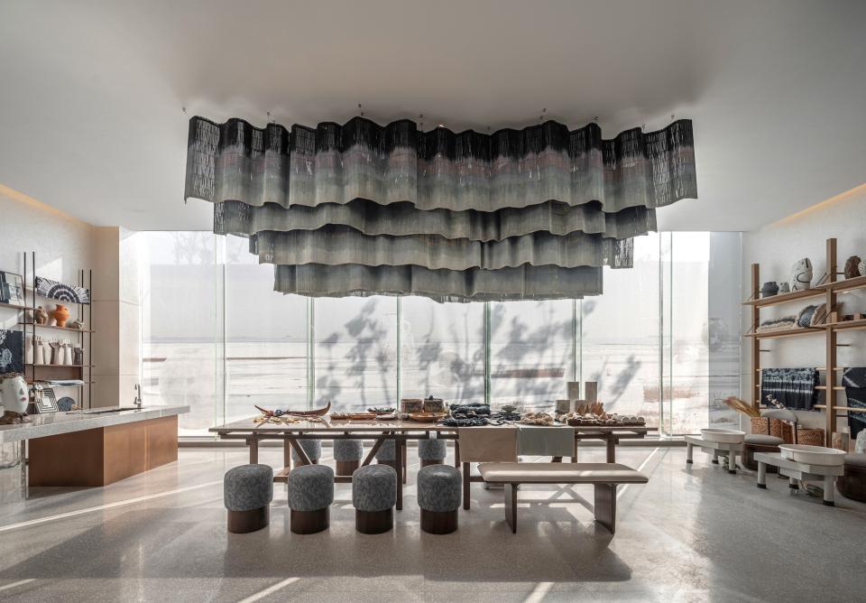 Sculptural hanging ceiling feature above a spacious exhibition table adorned with decorative items in Karv One's Leas hall.