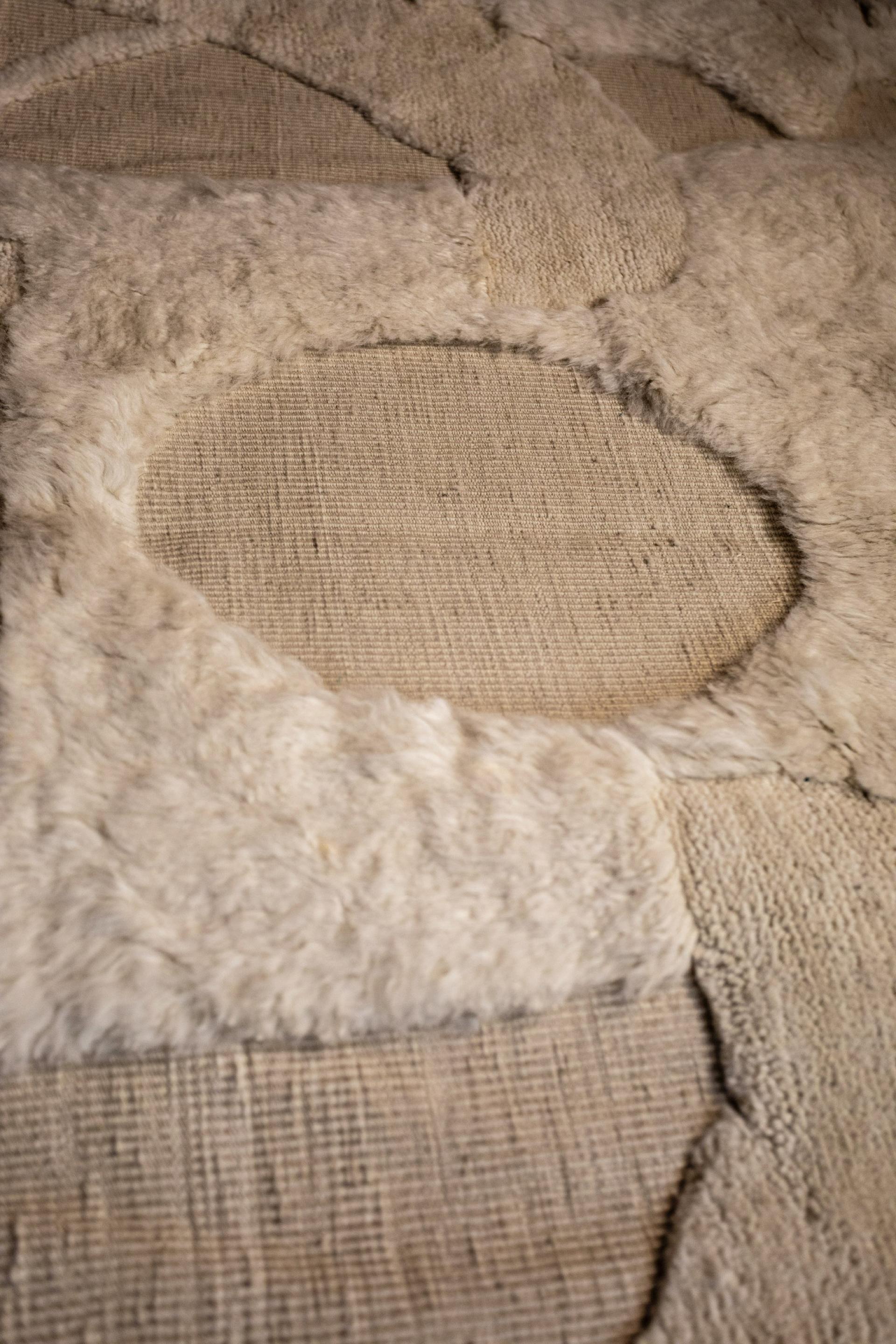 Textured textile artwork featuring layered materials, highlighting memory and the narrative of objects in Dharma Taylor's exhibition.