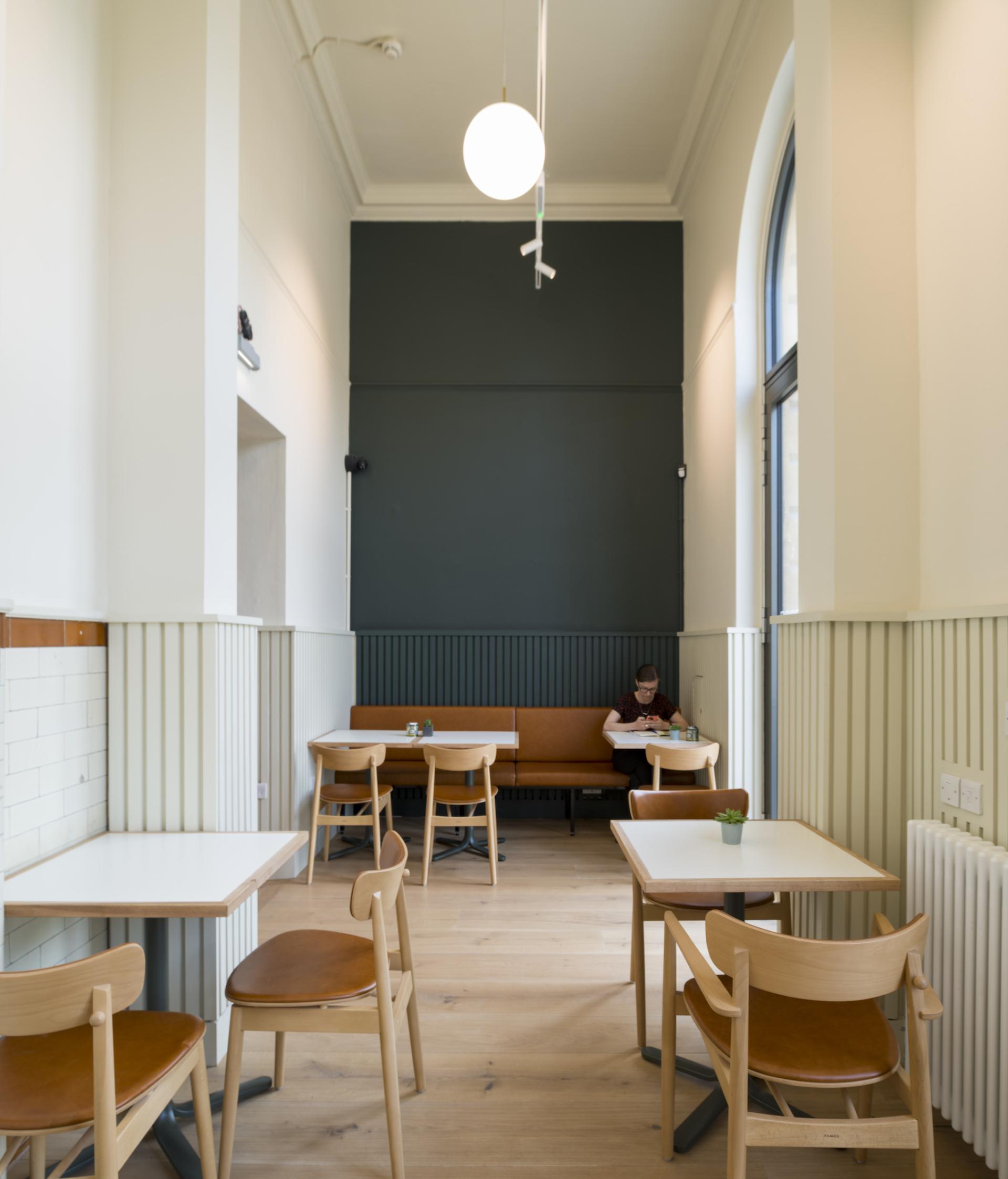 Bright, minimalistic interior of Spicer & Cole at Bristol’s Royal West of England Academy, featuring seating and natural light.