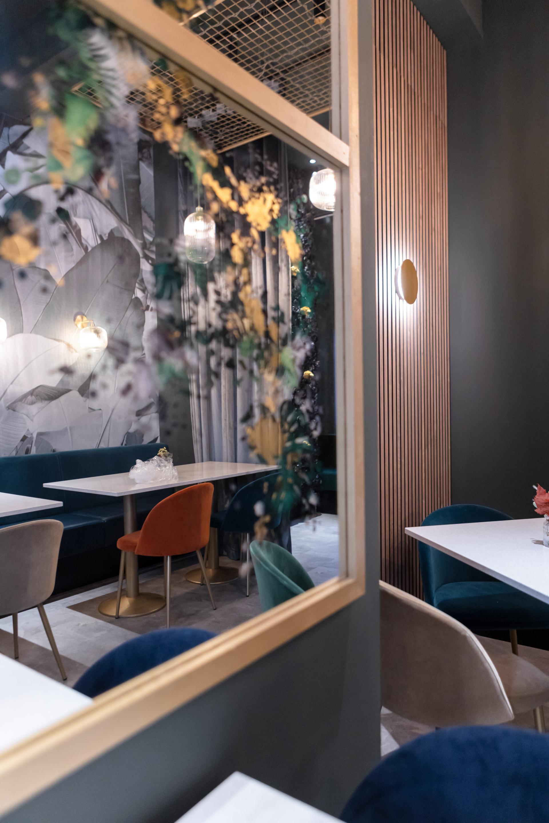 Stylish interior of a café featuring modern seating and decorative elements, reflecting the creativity of Eatock Design & Build.