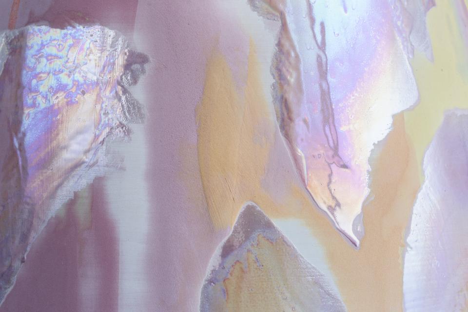 Close-up of Coralla Maiuri's iridescent Bottega d’Arte vase showcasing pearly colors and textured volcanic effects.