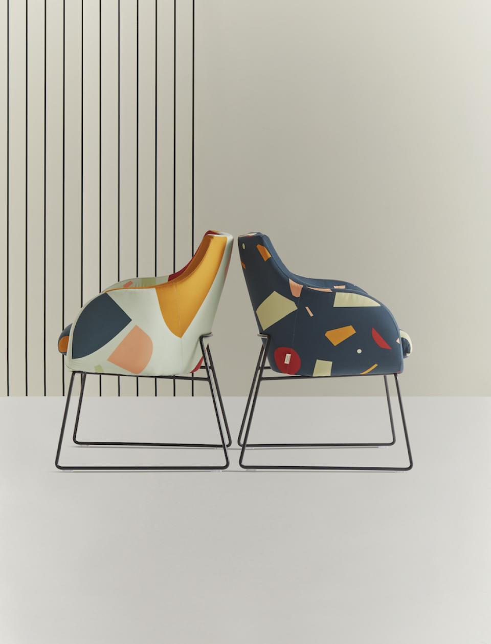 Colorful geometric chairs from Tom Pigeon collection designed by Roger Lewis, showcasing British craftsmanship and playful design.