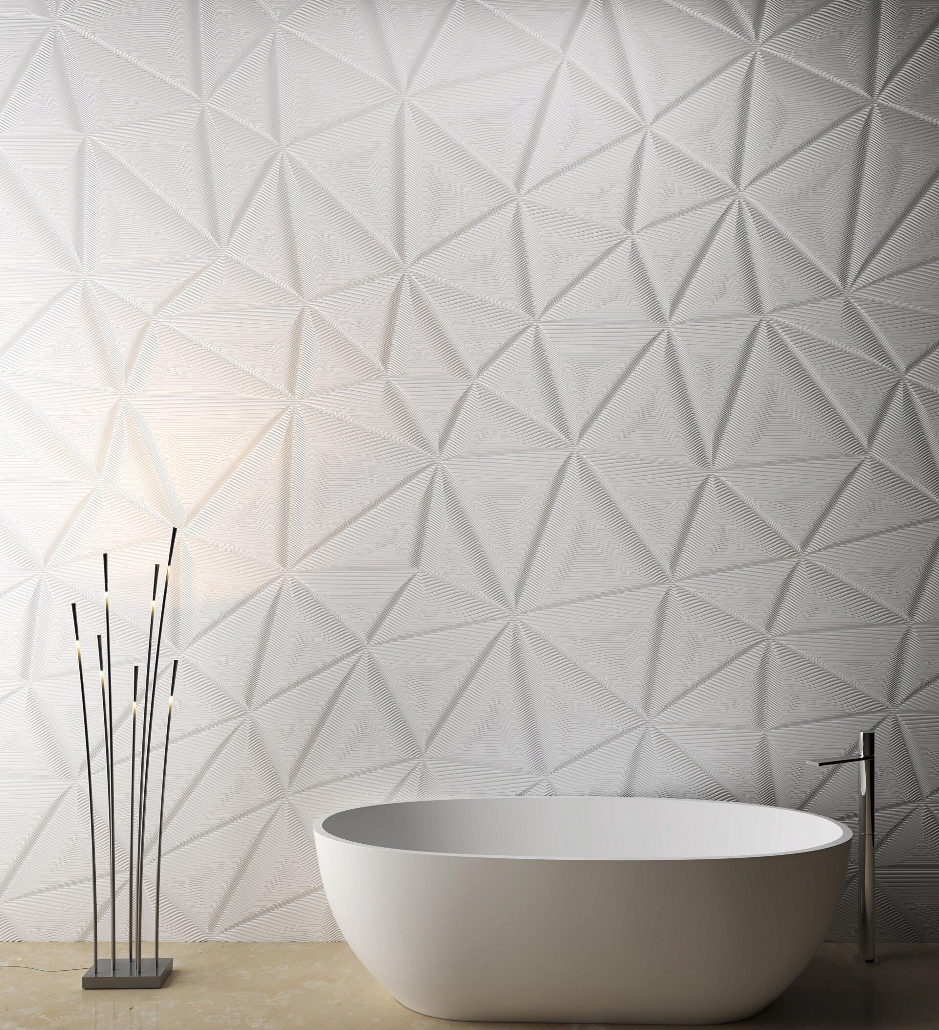 Textured white wall surface design with modern freestanding bathtub and contemporary floor lamp in a stylish bathroom.