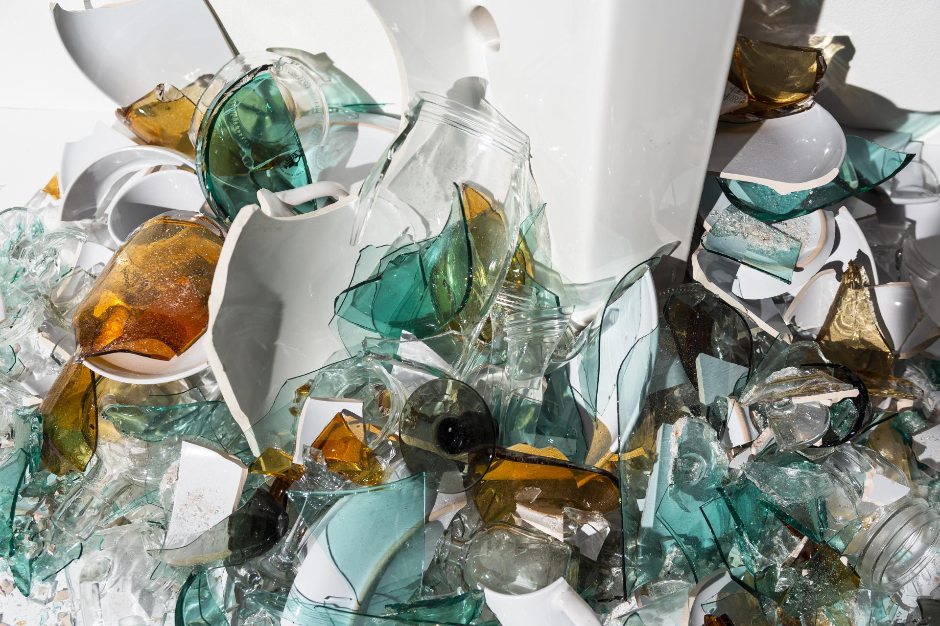 A pile of shattered glass and ceramics showcasing the potential for sustainable materials in design and recycling.