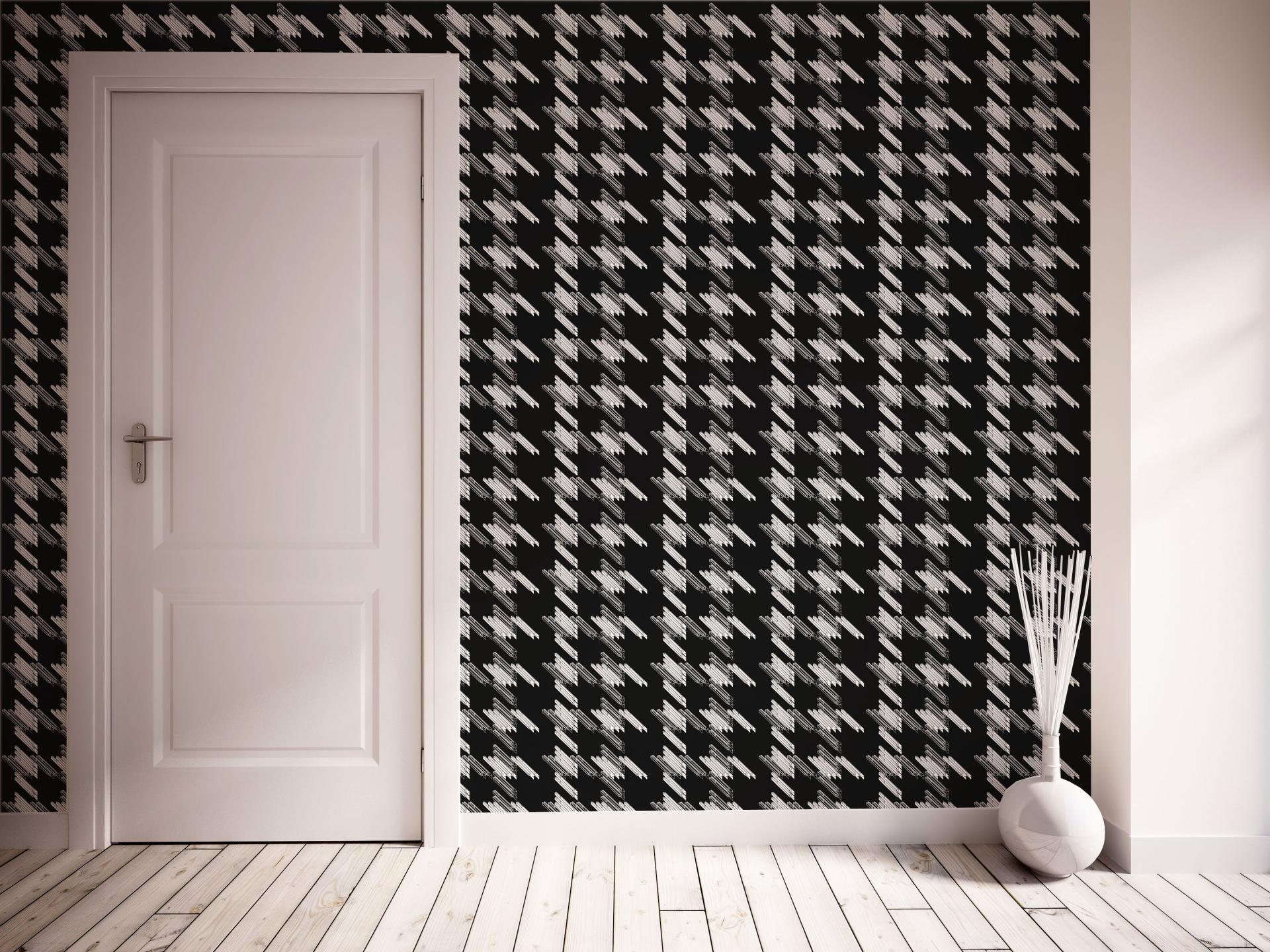 Stylish black and white houndstooth wallpaper in a modern Edinburgh interior, featuring a white door and vase.
