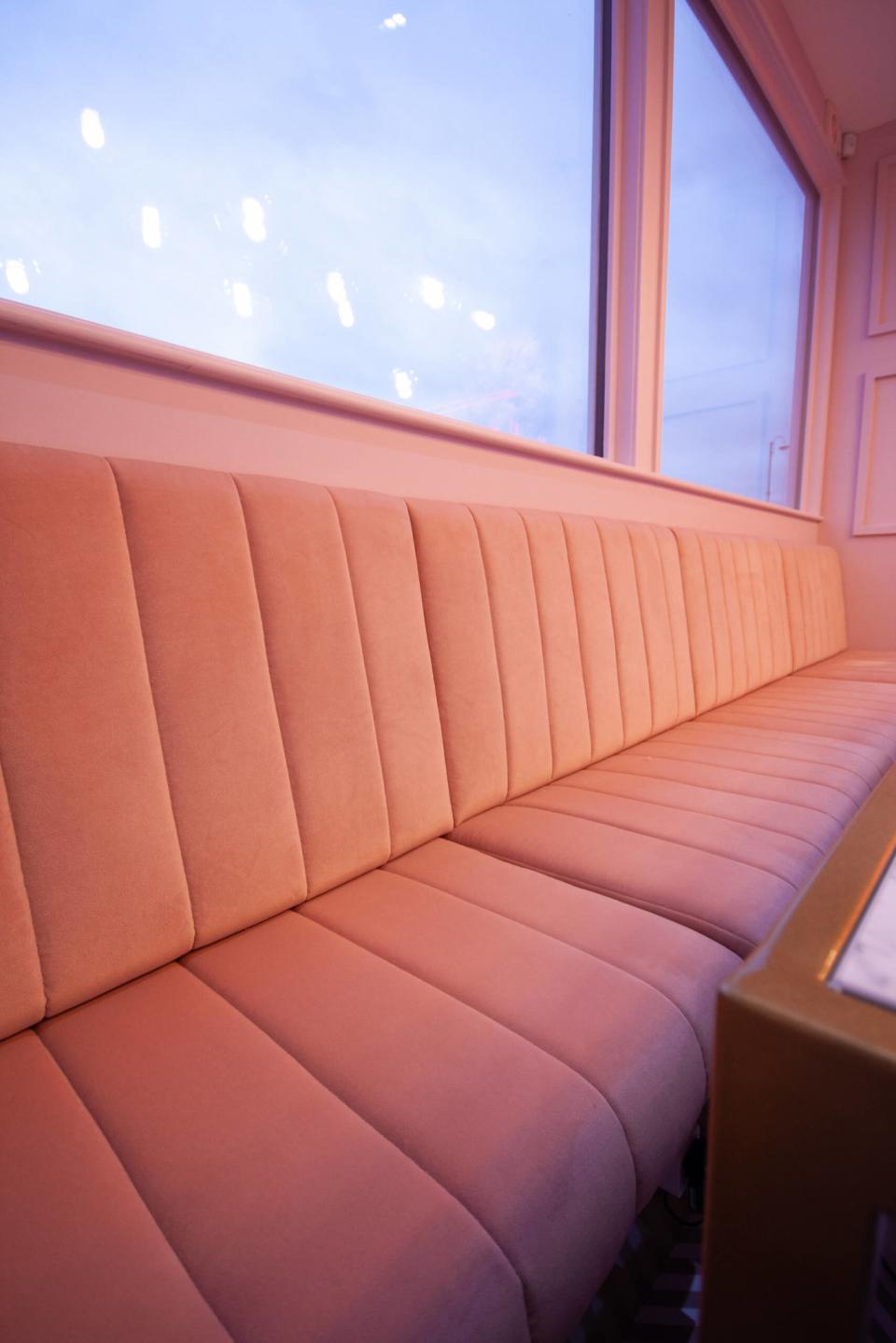 Stylish pastel pink seating in a Nailbox salon, emphasizing a modern, inviting atmosphere for customers.