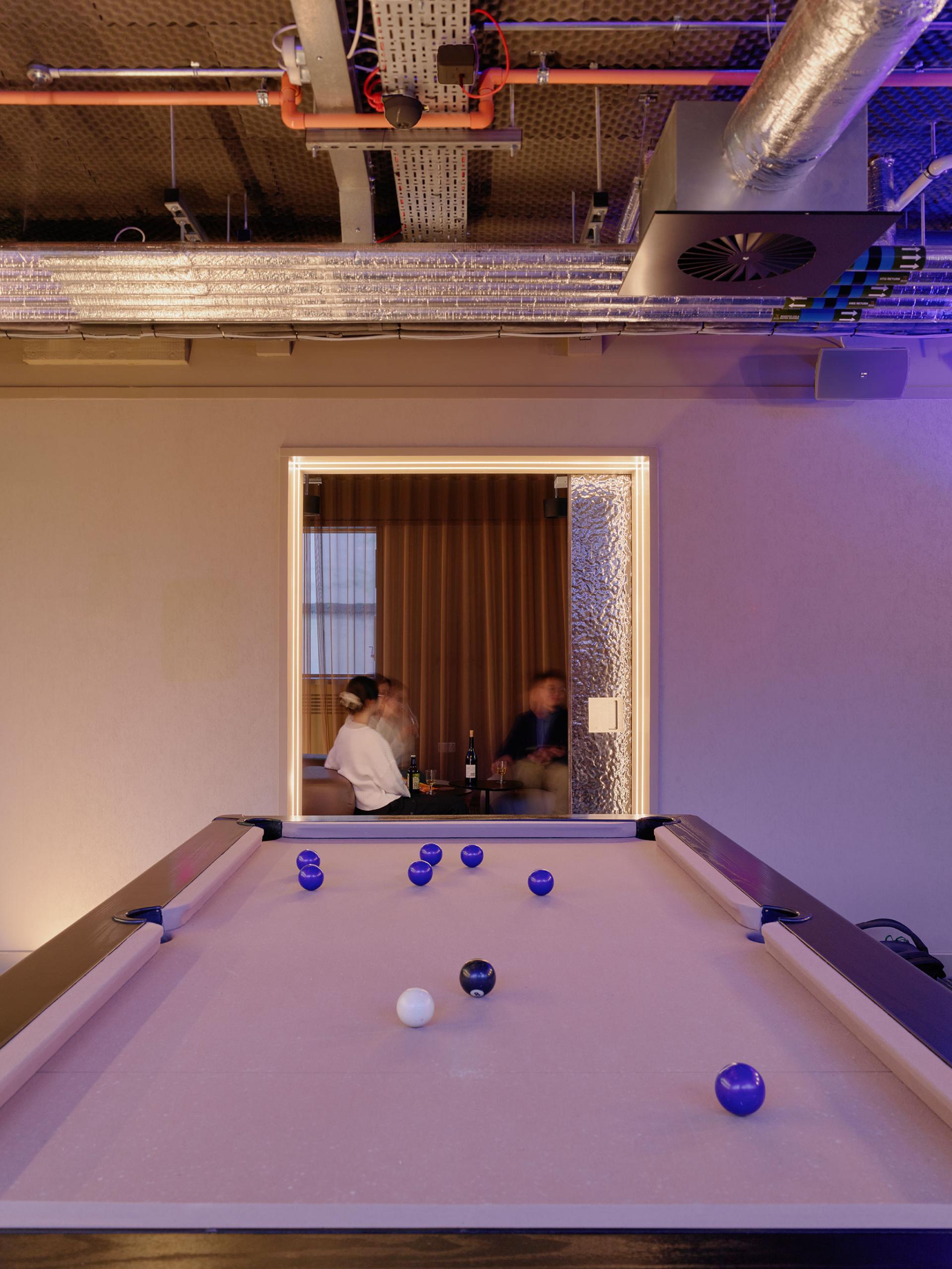 Atmospheric interior design featuring a pool table and social area at 16-18 Potterrow, Edinburgh by Jasper Sanders + Partners.