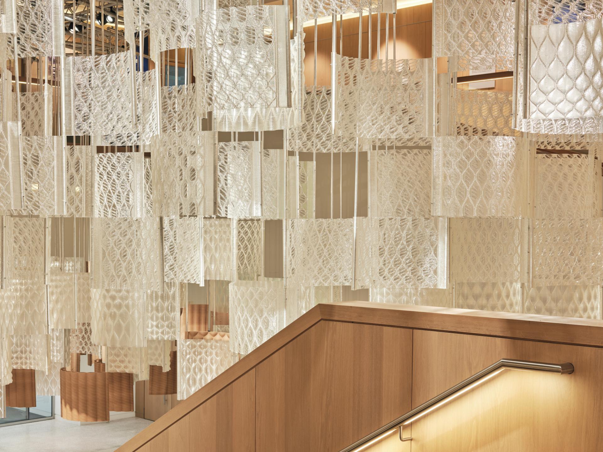 Exquisite installation of translucent panels with intricate patterns, showcasing innovative design at the Design Museum during COP26.