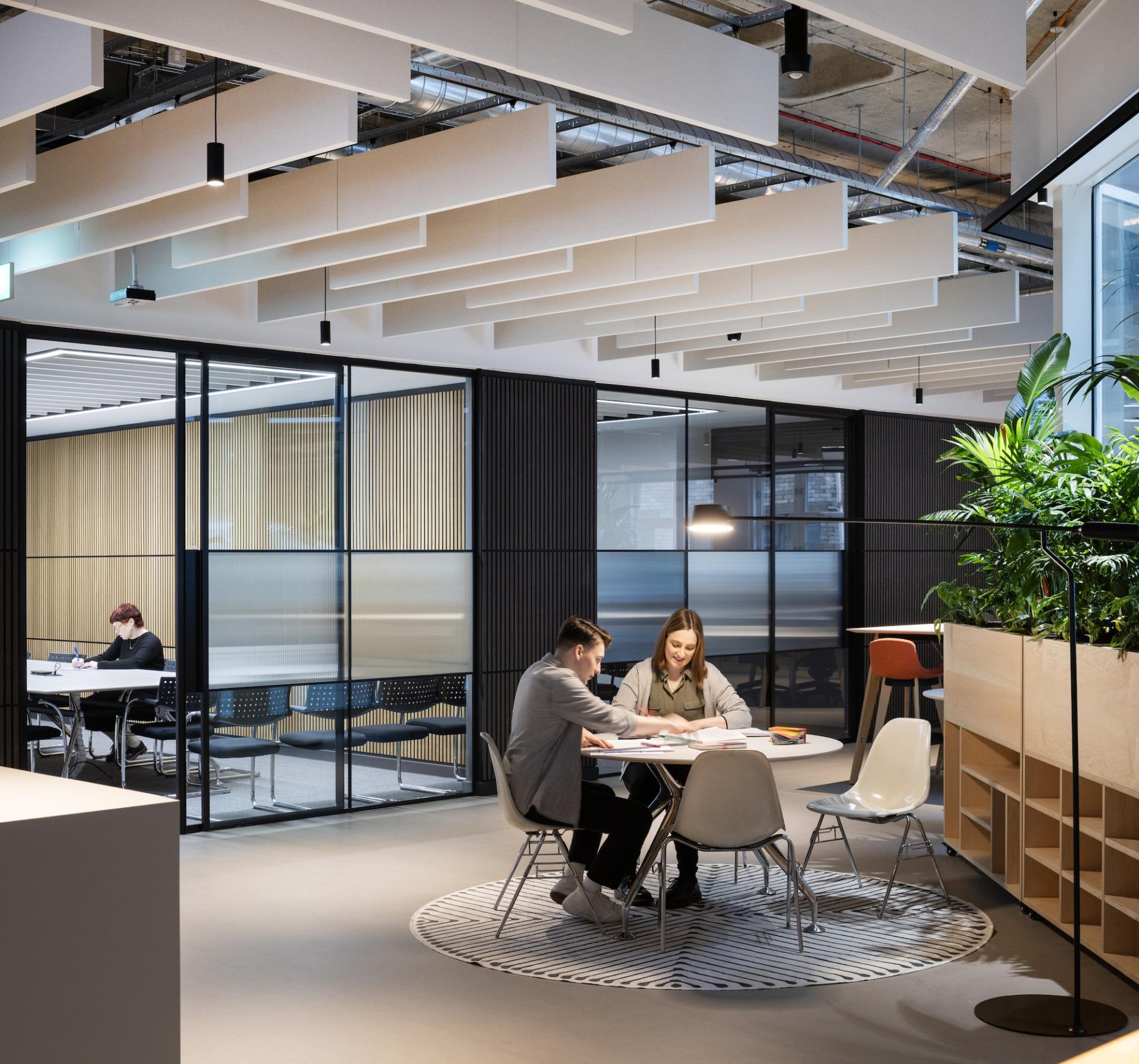 Modern office space at BDP Glasgow showcasing collaborative work areas and greenery in the historic Grosvenor Building.