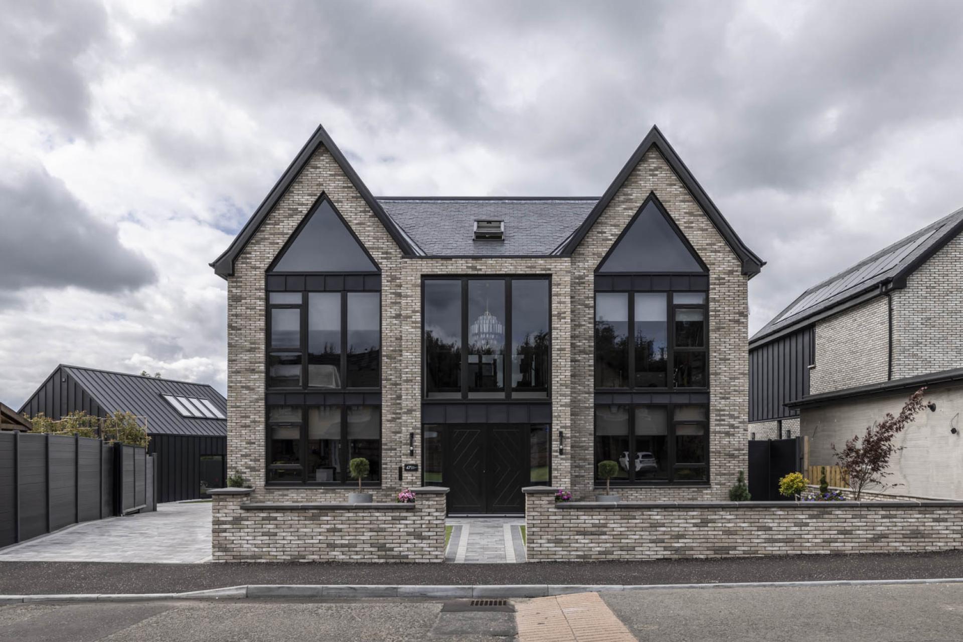 Stunning contemporary brick house with large windows and modern design, showcasing European architectural beauty.