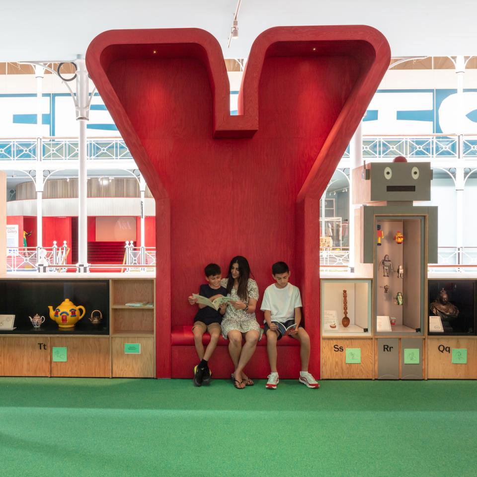 Children engaging in playful reading in a vibrant, child-friendly space at the Young V&A museum.
