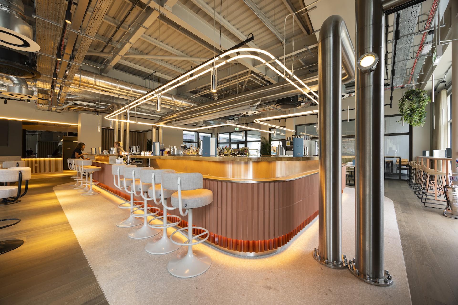 Modern bar interior of Junction at Manchester Central featuring a stylish countertop, sleek seating, and ambient lighting.