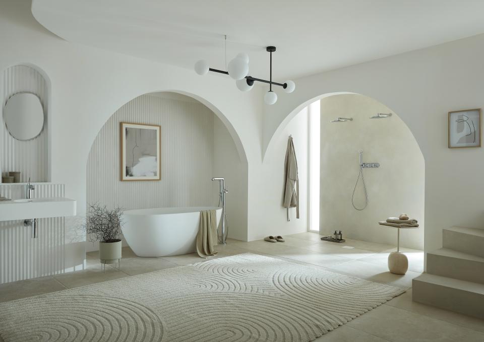 Modern bathroom design featuring a freestanding tub, sleek fixtures, and artistic accents from the VADO and Conran collaboration.