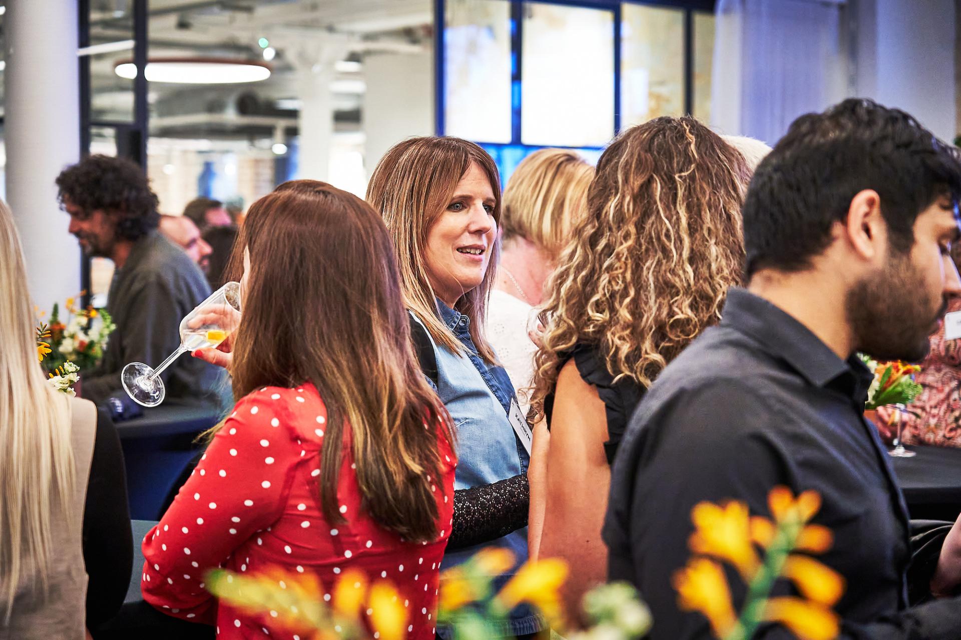 People engaged in conversation at the 42 Gathering event, celebrating the 42 Roles in the Built Environment podcast.