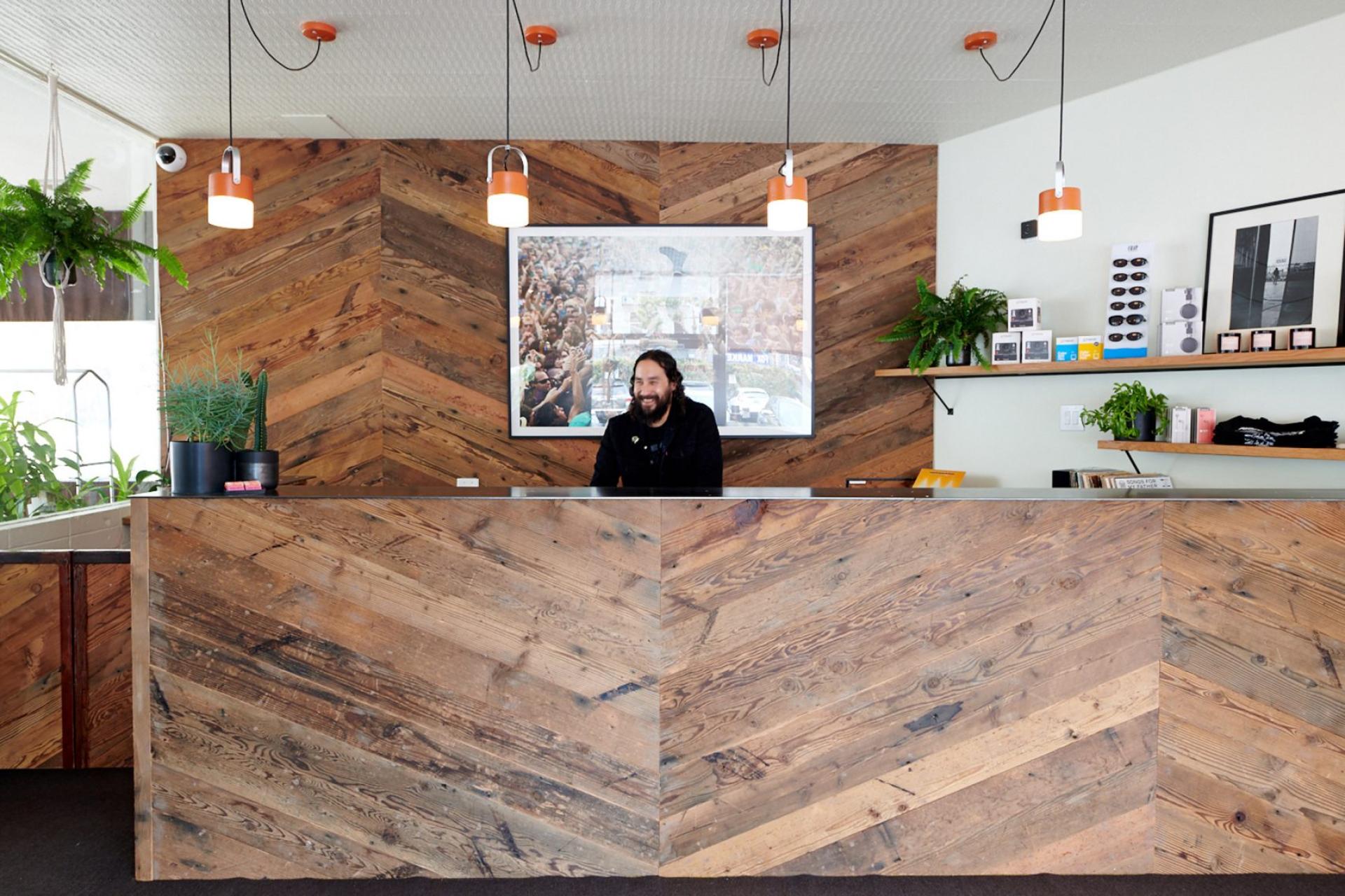 Stylish reception area of the Phoenix Hotel featuring natural wood accents and vibrant decor in San Francisco's Tenderloin.