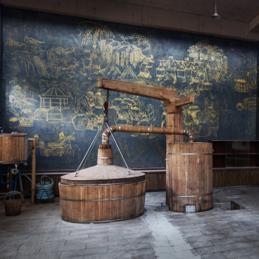 Traditional baijiu distillation equipment in a modern Chinese liquor factory, showcasing a unique sensory experience designed by SenseLab.