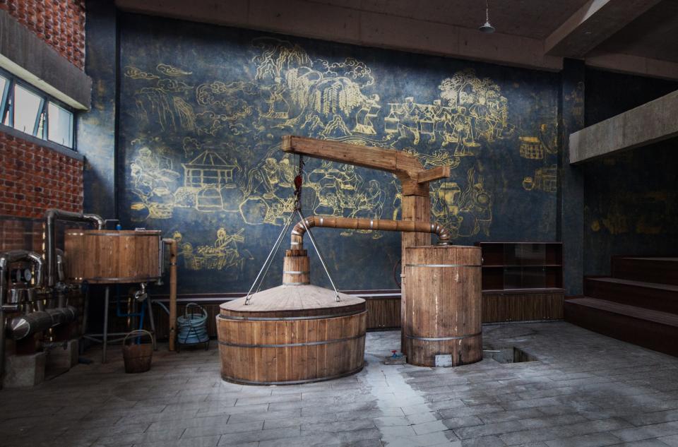 Traditional baijiu distillation equipment in a modern Chinese liquor factory, showcasing a unique sensory experience designed by SenseLab.