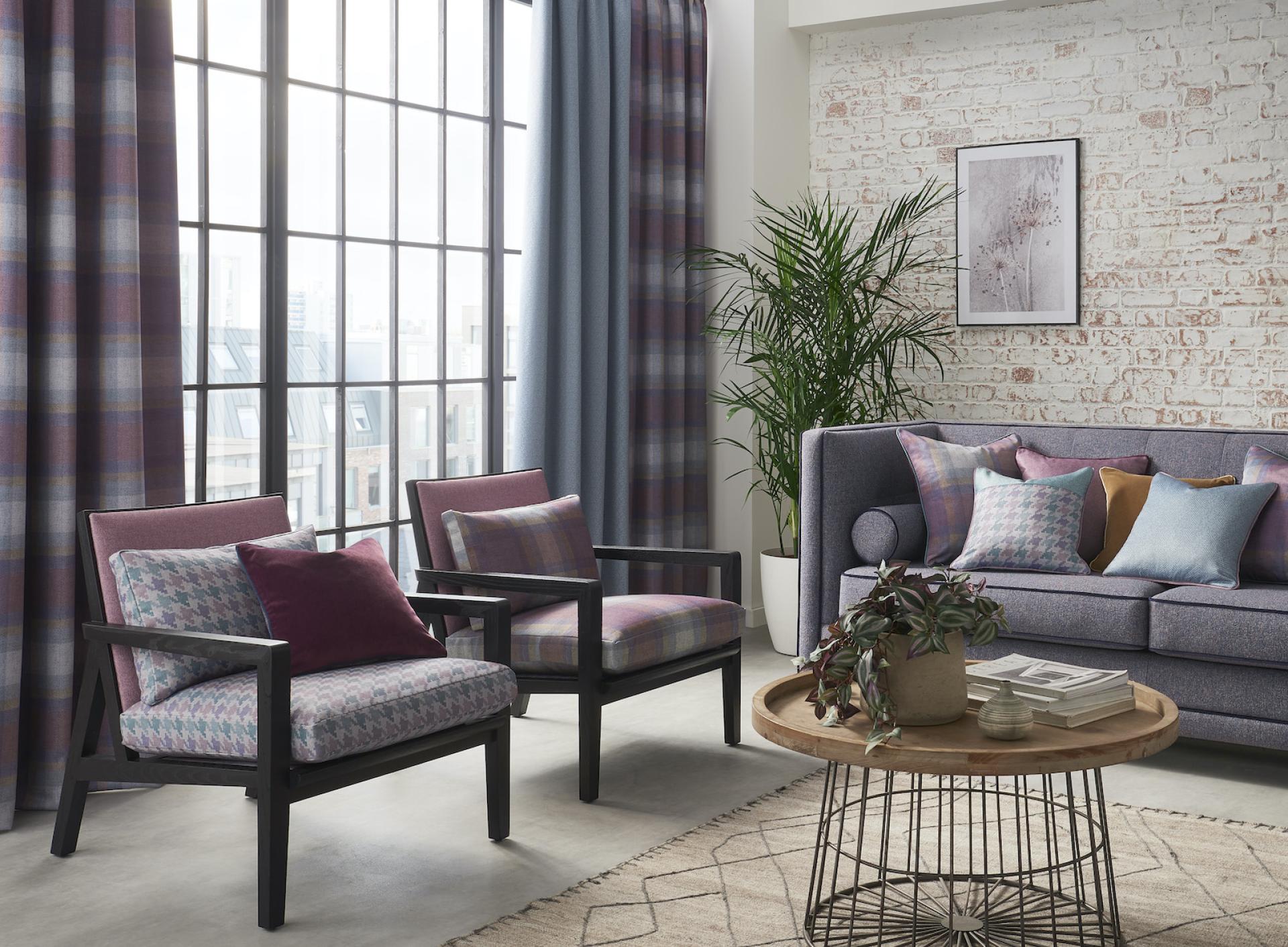 Stylish living room featuring decorative fabrics, modern furniture, and large windows, reflecting Panaz's innovative design approach.