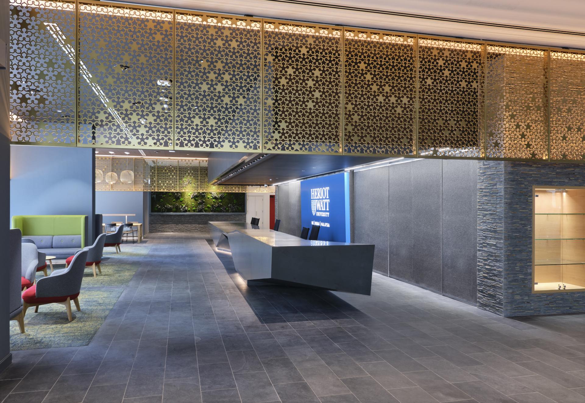 Modern interior of Heriot-Watt University's new Dubai campus featuring a sleek reception area and decorative wall design.