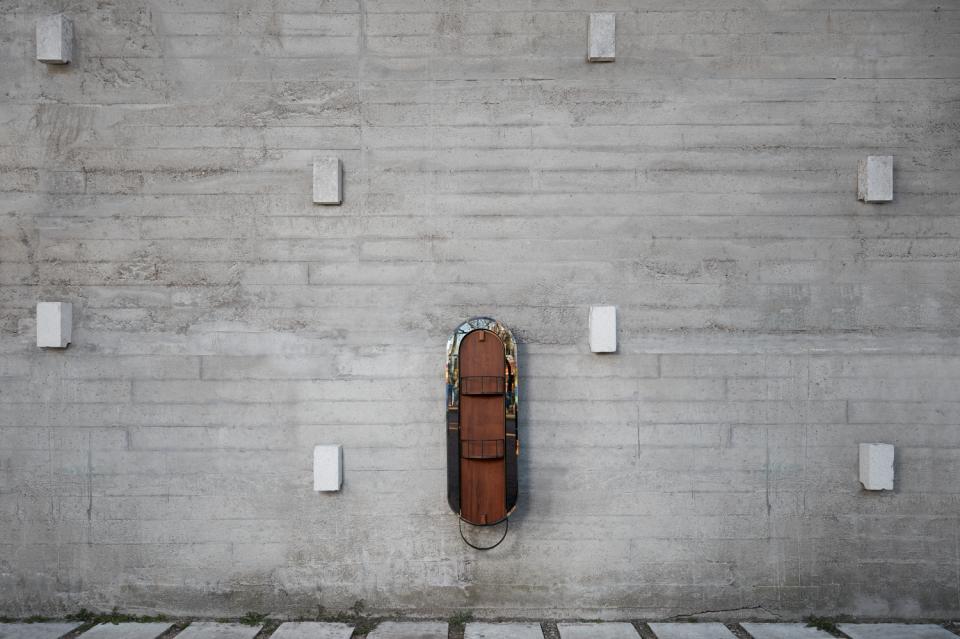 Modernist-inspired design piece by Julio Vilamajó showcased on a textured concrete wall, highlighting innovative Uruguayan craftsmanship.