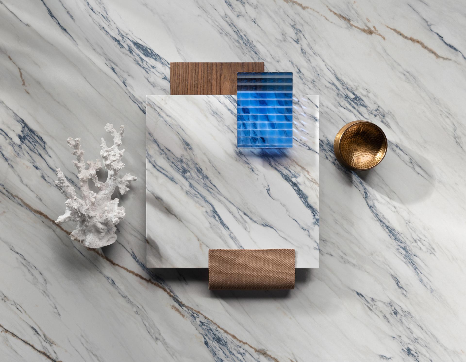 Elegant Dekton® surfaces showcase Onirika and Kraftizen collections, featuring marble patterns, textured elements, and decorative objects.