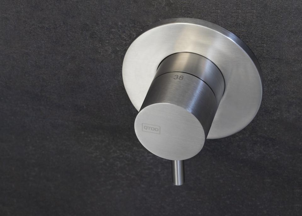 Sleek, modern shower control valve in brushed stainless steel designed for d line's innovative sanitary ware collection.