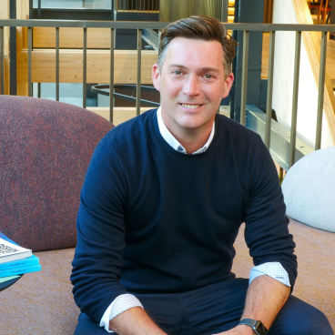 John Badman, Gensler's residential leader, seated in a contemporary office space, promoting innovative design for multi-purpose living.