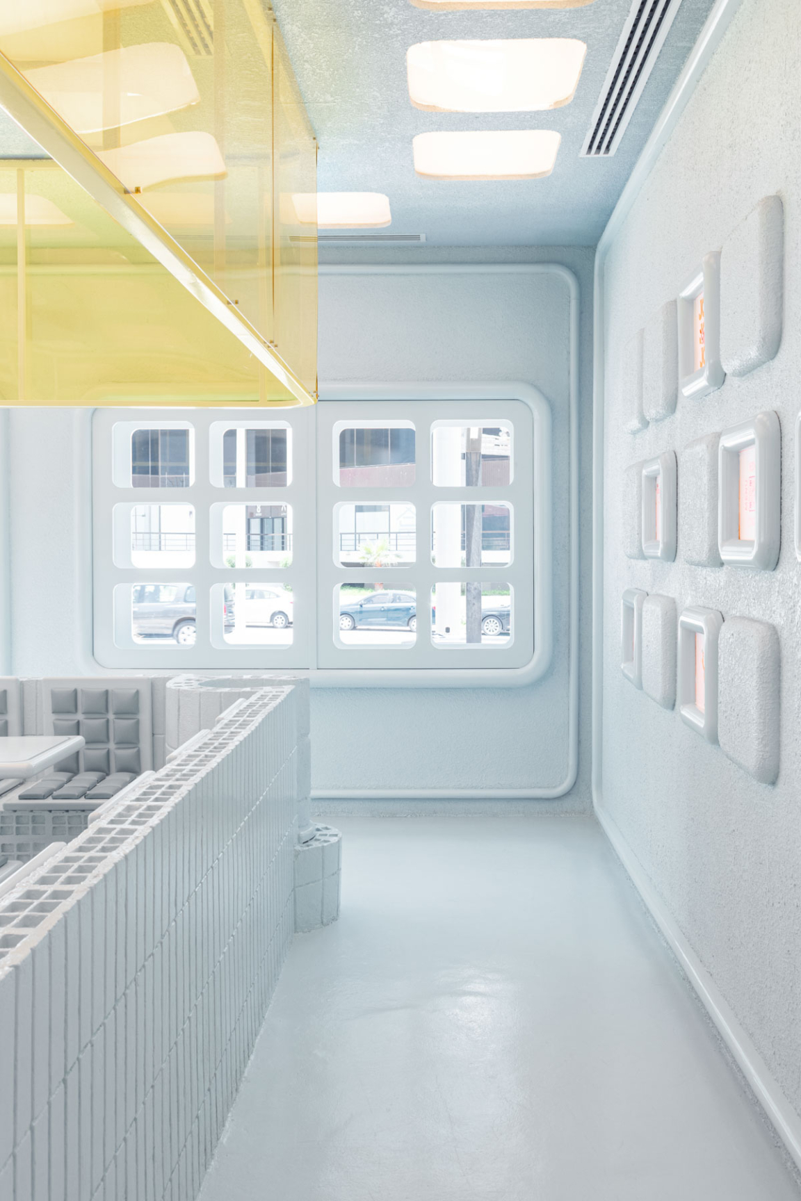 Futuristic interior design of the Novu Waffle, featuring sleek white walls, colorful accents, and unique structural elements.