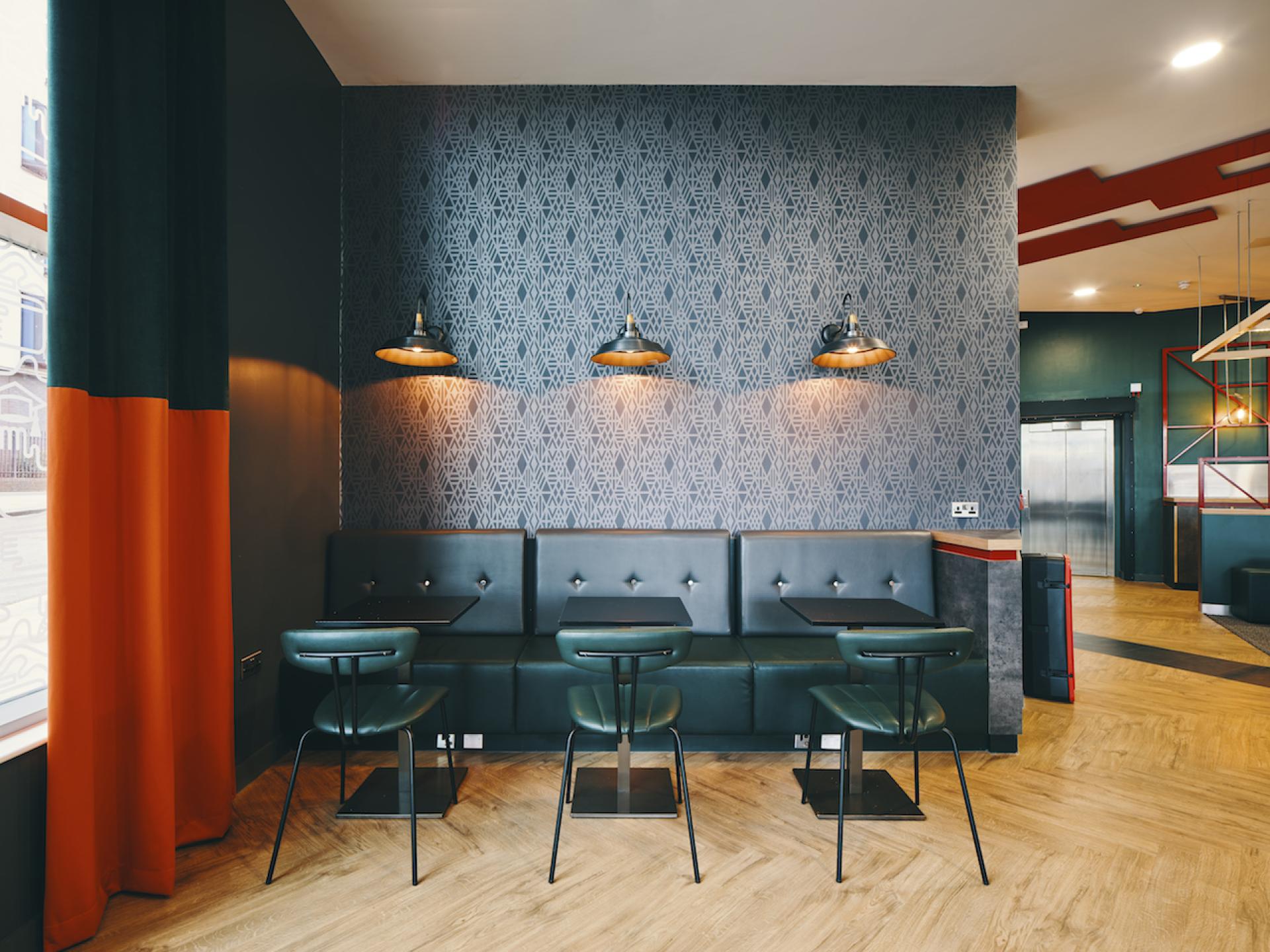 Stylish interior design of Knight House at the University of Sheffield, featuring modern seating and decorative wall patterns.
