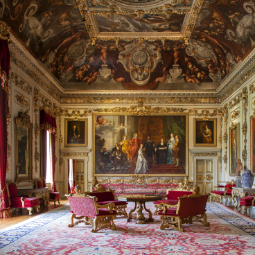 Luxurious historic interior featuring ornate decor, grand paintings, and elegant furnishings in a British manor.