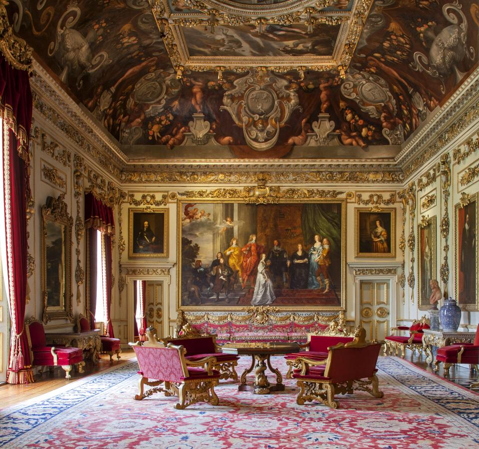 Luxurious historic interior featuring ornate decor, grand paintings, and elegant furnishings in a British manor.