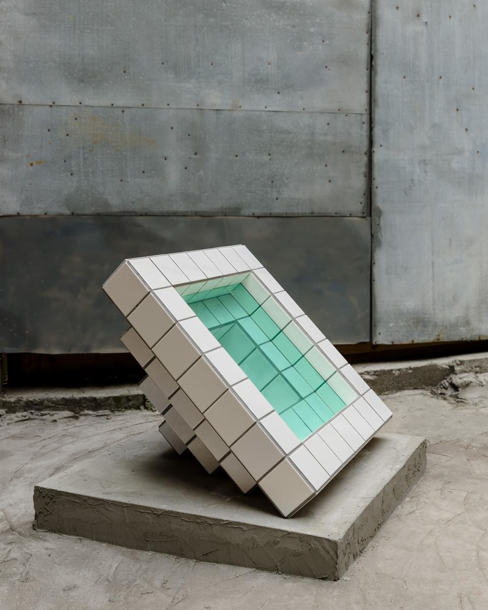 Sculpture by artist Zac Hacmon featuring subway tiles and glass, showcasing innovative design and artistic expression.