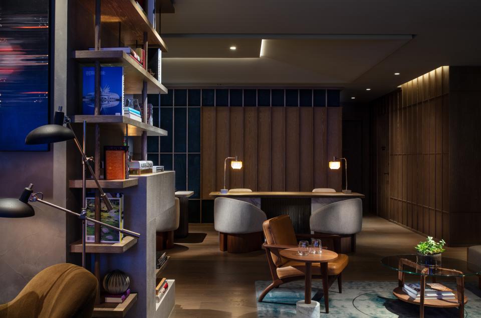 Elegant hotel lobby showcasing modern design elements, bookshelves, and cozy seating at The Hari Hong Kong.