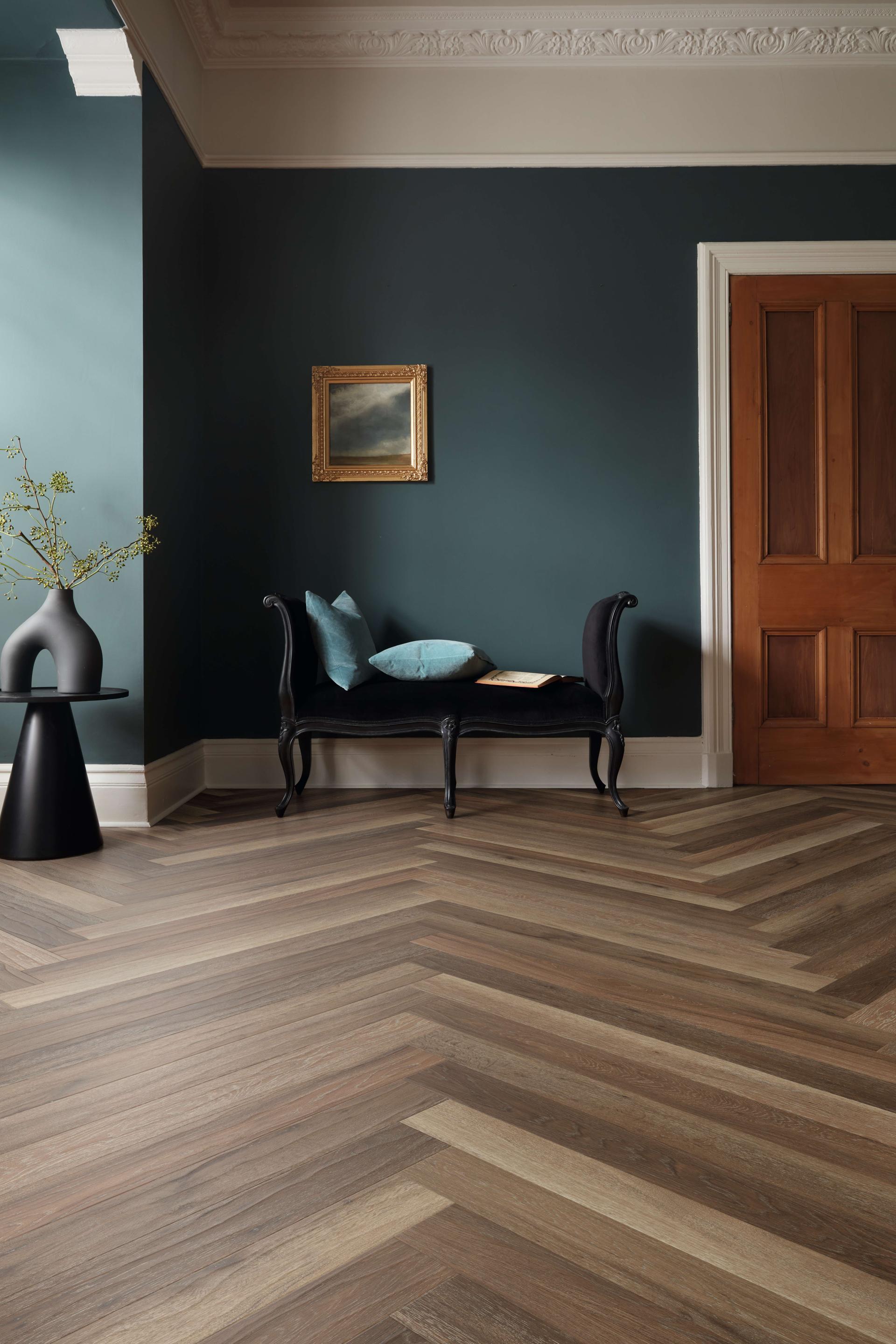 Elegant interior featuring Karndean's Art Select wood flooring in a stylish chevron pattern and decorative furnishings.