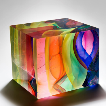 Vibrant glass sculpture by Tim Rawlinson featuring swirling colors and intricate patterns at London Glassblowing exhibition.