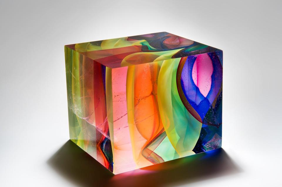 Vibrant glass sculpture by Tim Rawlinson featuring swirling colors and intricate patterns at London Glassblowing exhibition.